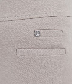 Pants with elastic fabric pockets
