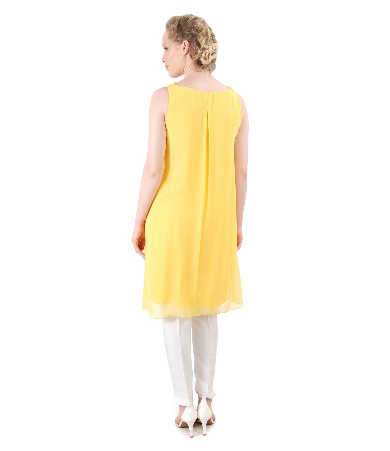 Elegant outfit with veil dress and ankle pants