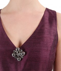 Taffeta dress with accessory brooch on decolletage