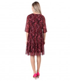 Dress with ruffles made of printed veil with paisley motifs