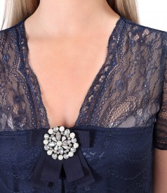 Lace dress with brooch at the neckline