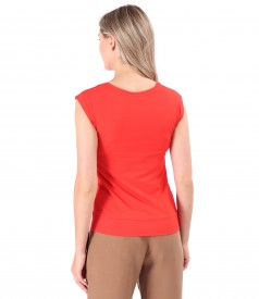 Elastic jersey blouse with decorative element on the shoulder