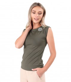 Elastic jersey blouse with decorative element on the shoulder