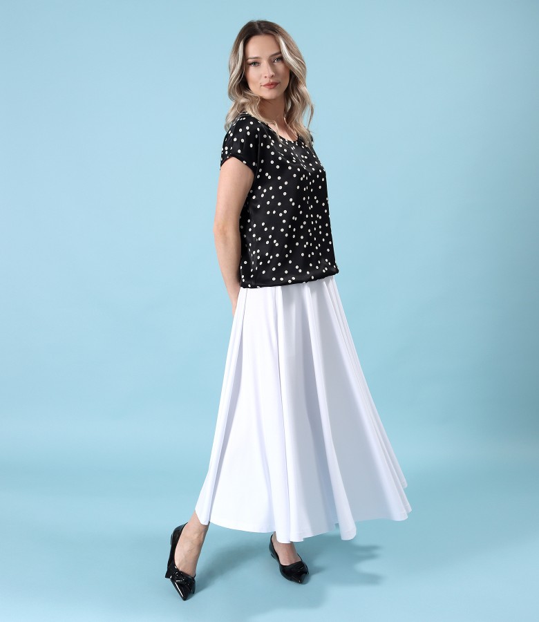 Elegant outfit with long skirt and viscose blouse with polka dots