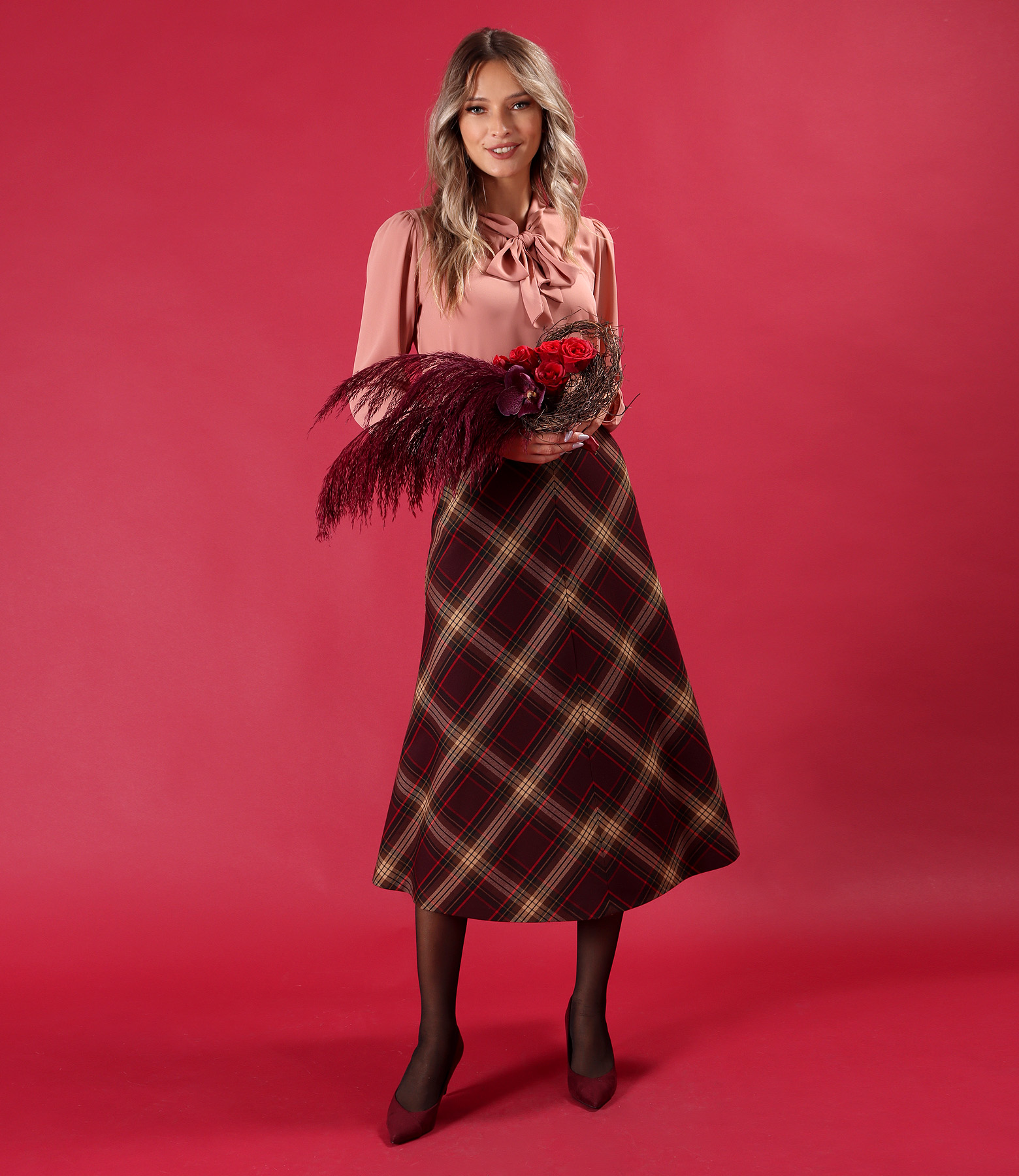 Elegant outfit with checked midi skirt and blouse with scarf collar