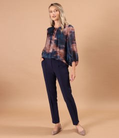 Elegant outfit with ankle pants and printed veil blouse