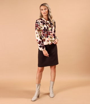 Short flared skirt with a blouse featuring a scarf-style collar