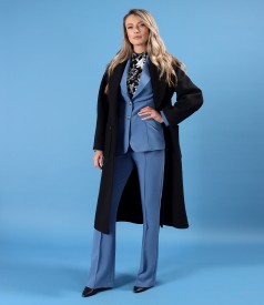 Elegant outfit featuring a thick-fabric overcoat and a suit with a jacket and pants