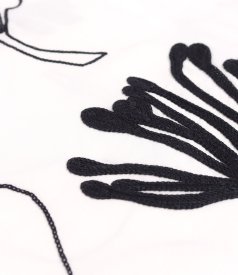 Long dress in embroidered cotton with floral motifs