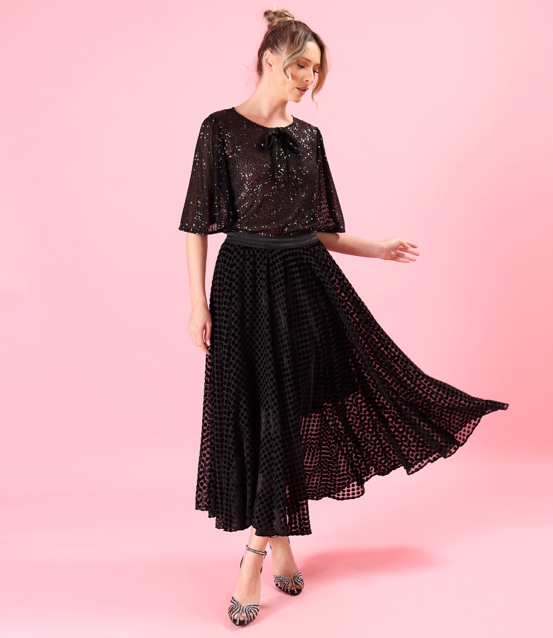 Elegant outfit with sequin blouse and long polka dot veil skirt