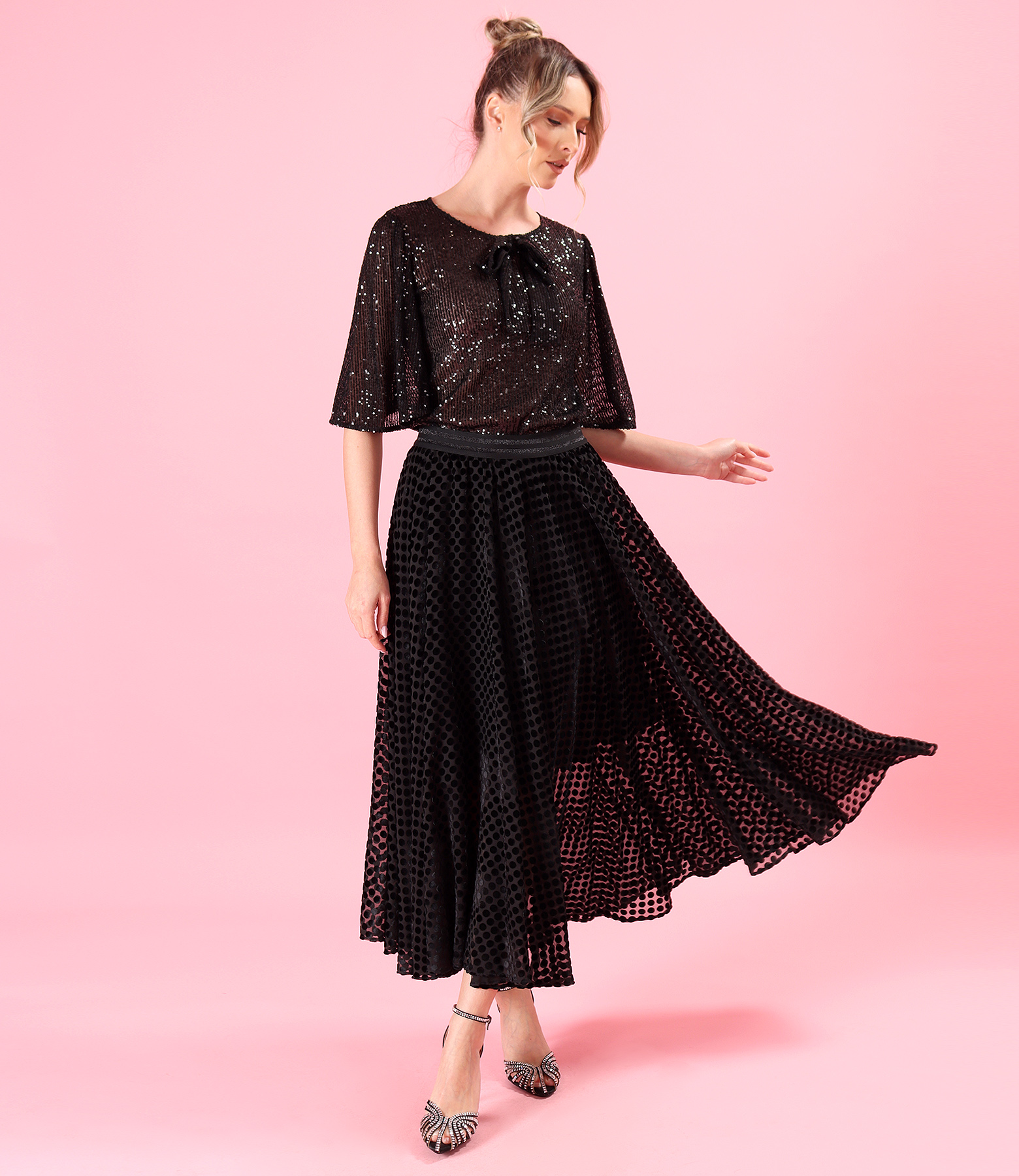 Elegant outfit with sequin blouse and long polka dot veil skirt